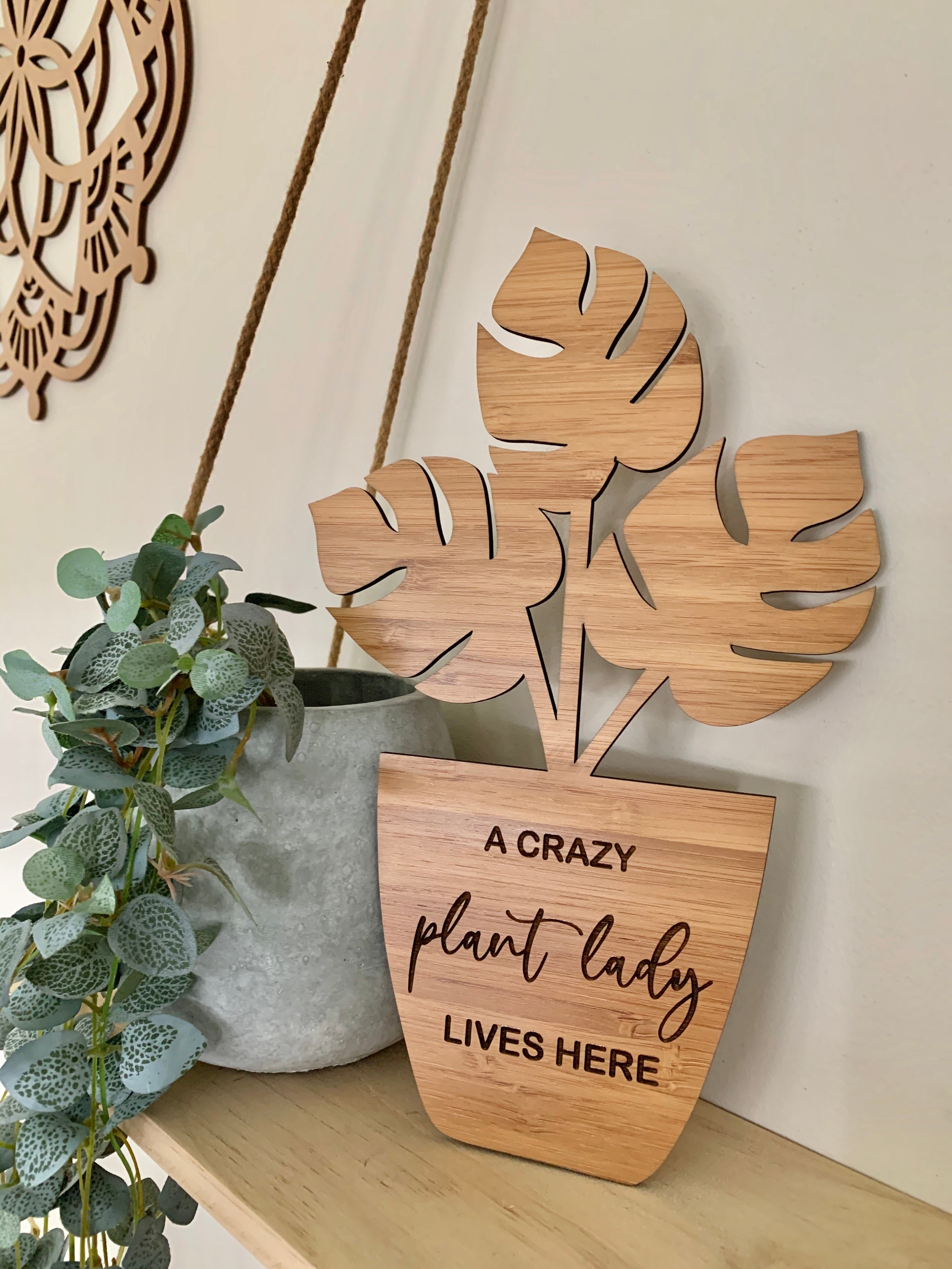 “A CRAZY PLANT LADY LIVES HERE” PLAQUE